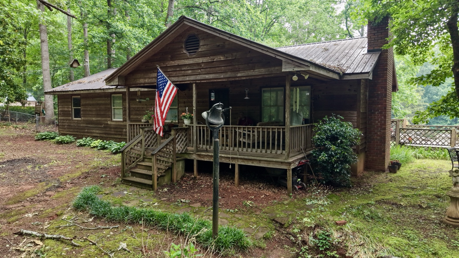 Cabin with American flag on porch